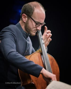 Ori Epstein playing cello with the Busch Trio
